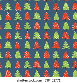 Decorative green and red pine trees over blue background vector seamless pattern