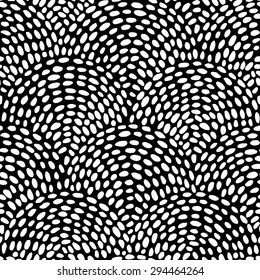 Decorative hand drawn seamless vector pattern. Simple semi-circular elements. Ethnic style black and white minimalistic background. Wavy hand drawn dashed lines arranged in circles.
