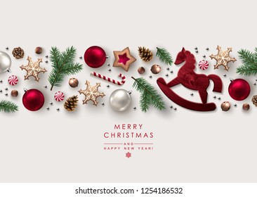 Decorative Horizontal Border made of Christmas Ornaments, Pine Branches, Snowflakes, Cookies and Candy Canes. Flat lay, top view.