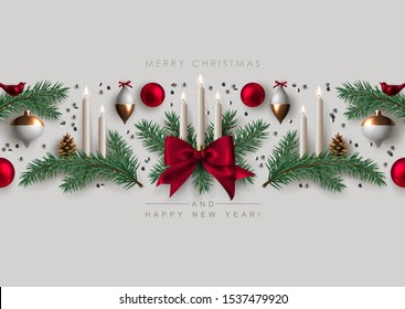 Decorative Horizontal Border made of Christmas Ornaments, Pine Branches, and Burning Candles. Flat lay, top view.