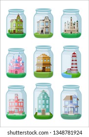 Decorative houses in glass jar on white background.