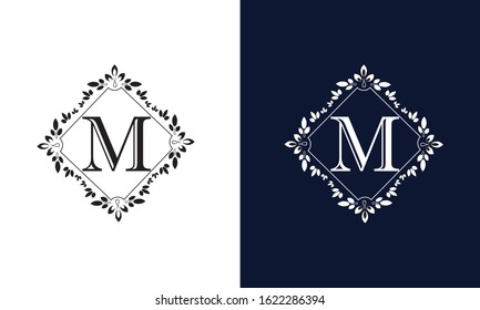 Decorative monogram flower with letter M on white and black background. Design with ornament of emblem of enterprise, organization, institution.
