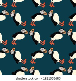 Decorative nature wild seamless pattern with black and white colored puffin bird shapes. Blue background. Flat vector print for textile, fabric, giftwrap, wallpapers. Endless illustration.