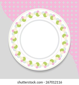 Decorative plate on gray background, top view