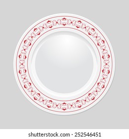 Decorative plate with patterned border, on gray background, top view. 