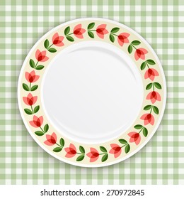 Decorative plate with  patterned floral border, on gingham tablecloth. Blank plate, top view. Vector illustration.