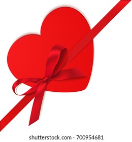 Decorative red bow with diagonally ribbon and heart on the corner. Vector bow for page decor isolated on white