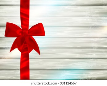 Decorative red ribbon and bow on a background of white painted rustic boards with copyspace. EPS 10 vector file included