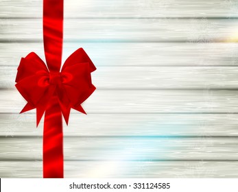 Decorative red ribbon and bow on a background of white painted rustic boards with copyspace. EPS 10 vector file included
