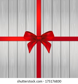 Decorative red ribbon and bow over wooden background. vector 