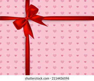 Decorative red shiny ribbon knot. Gift pack wrap paper with heart shapes pattern.