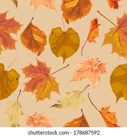 decorative seamless pattern with autumn leaves in orange and brown colors