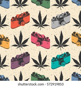 Decorative seamless pattern with black cannabis leaves and color old camera on desert yellow background, wrapping paper. vector illustration