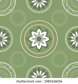 Decorative seamless pattern. Ethnic textile decorative ornament. White pattern on a green background.  Great for fabric and textile, wallpaper, packaging or any other idea.