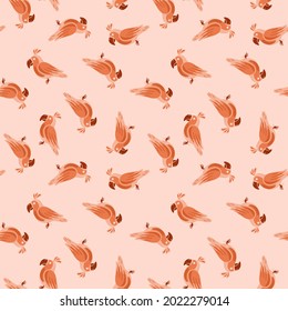 Decorative seamless pattern with orange random little parrots shapes print. Pastel pink background. Designed for fabric design, textile print, wrapping, cover. Vector illustration.