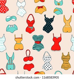 Decorative seamless pattern with swimsuits. Dry brush painted swimwear, trendy texture. Hand drawn endless stylish backdrop. Colorful beachwear on light pink background for fabric, wallpaper, wrapping