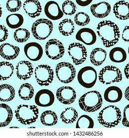 Decorative seamless pattern with textured black rings. Endless abstract ornament with jagged circles.