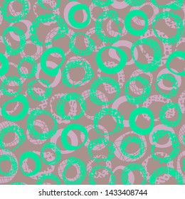 Decorative seamless pattern with textured green and pink rings on brown background. Endless abstract ornament with jagged circles.