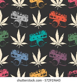 Decorative seamless pattern with white cannabis leaves and color old camera on black background, wrapping paper. vector illustration