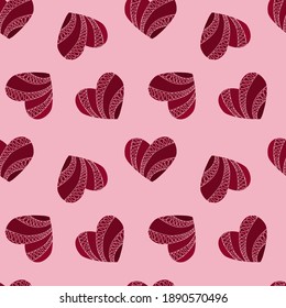 Decorative seamless texture with red hearts on light pink background. Colorful vector illustration in doodle style. Valentine`s Day symbol. For packaging, textile, wedding cards.