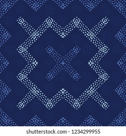 Decorative seamless vector pattern with shapes created from hand drawn dots. Creates an abstract look with tribal appeal for textile, fashion, quilting, wallpaper, home decor and graphic design work.