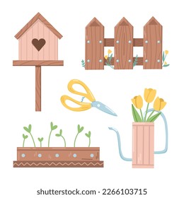 Decorative set of a wooden birdhouse, a fence, a watering can, pot with seedlings and garden shears