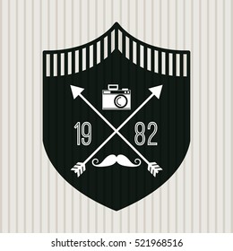 decorative shield with camera and mustache icons inside. hipster style design. vector illustration