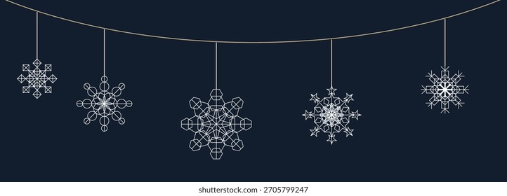 Decorative snowflakes hanging on a string against a dark background during winter festive season