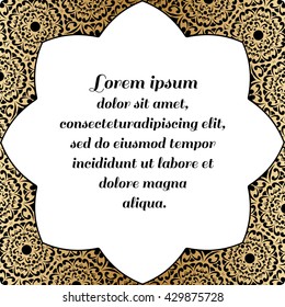 Decorative square element with a black pattern on a gold background.