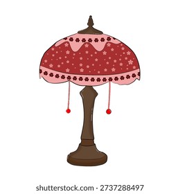 A decorative table lamp with a brown base and stem, topped by a red lampshade adorned with pink floral patterns and delicate beaded tassels.