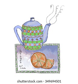 decorative teapot with orange on the tablecloth