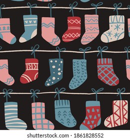 Decorative vector seamless pattern with Christmas socks. Colorful hand drawn background with traditional winter holiday decoration.