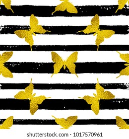 Decorative vector seamless pattern with golden butterflies on a striped black and white background