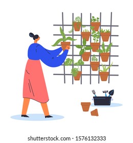 Decorative vertical garden concept.Woman gardener grows plants in pots.Environment friendly eco design.A new way to decorate the interior with house greenery.Modern hobby.Vector flat illustration