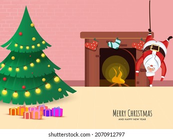 Decorative Xmas Tree With Gift Boxes, Santa Claus Hanging Upside Down And Fireplace On The Occasion Of Merry Christmas And New Year.