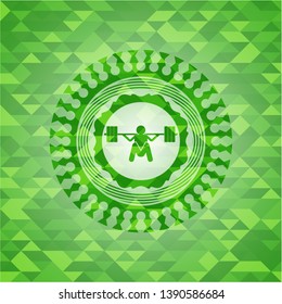 deep squat icon inside green emblem with triangle mosaic background