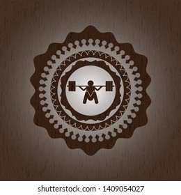 deep squat icon inside wooden emblem