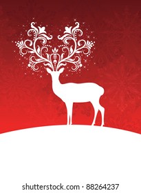 Deer with patterned horns standing on a hill.