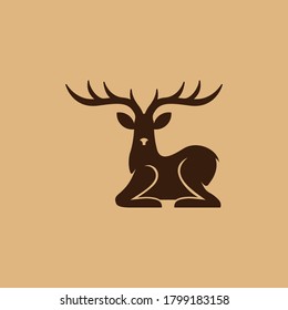 Deer sitting.  Animal wildlife vector silhouette.