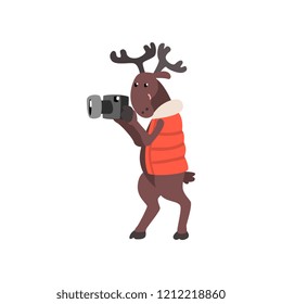 Deer in warm vest taking pictures with a camera, funny animal cartoon character traveling on vacation vector Illustration on a white background
