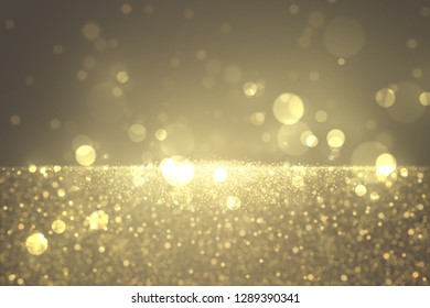Defocused glitter dust effect. Sparkling golden particles abstract luxury background