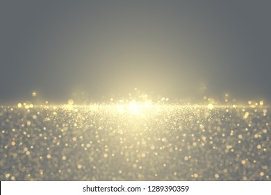 Defocused glitter dust effect. Sparkling golden particles abstract luxury background