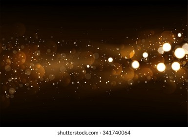 Defocused glitter lights background in dark gold and black colors.