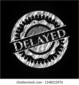 Delayed chalk emblem written on a blackboard