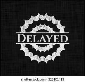 Delayed chalk emblem written on a blackboard