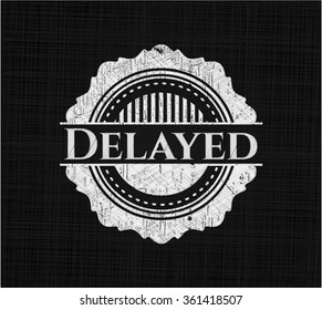 Delayed chalk emblem written on a blackboard