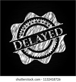Delayed chalkboard emblem written on a blackboard