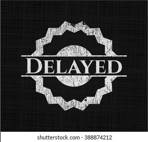 Delayed chalkboard emblem written on a blackboard