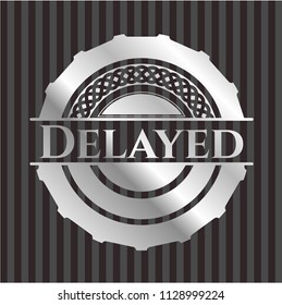 Delayed silvery emblem or badge