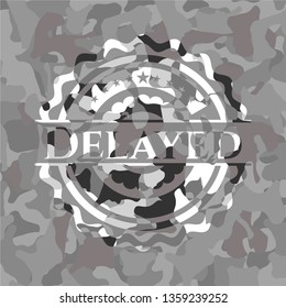 Delayed written on a grey camouflage texture